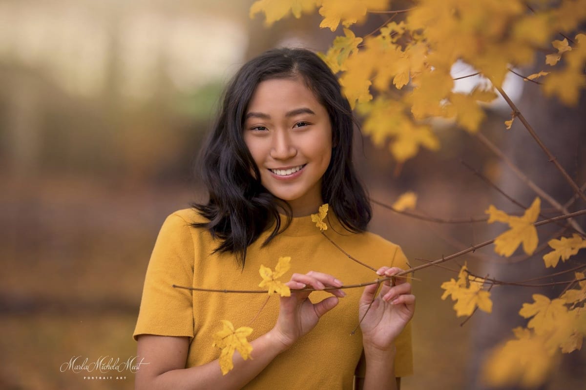 yellow-themed senior picture with yellow shirt and yellow leaves on tree