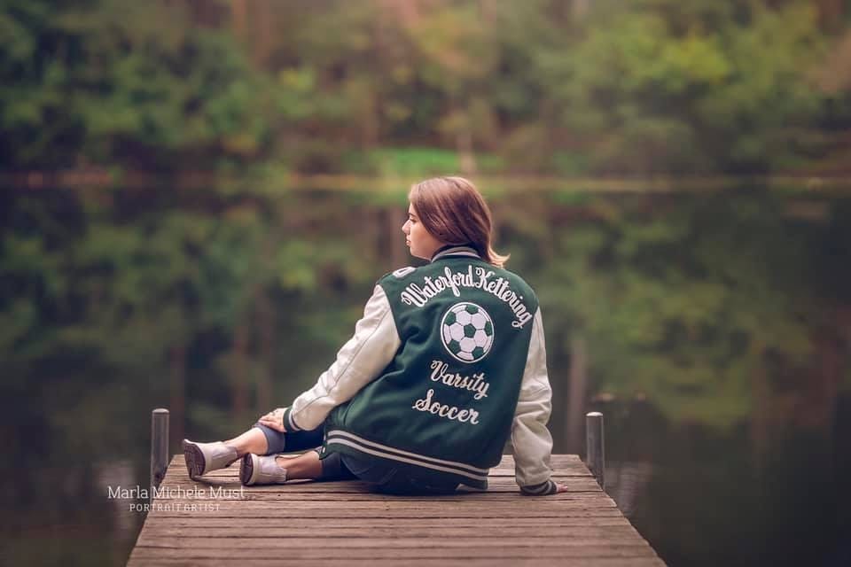 Michigan senior picture with varsity soccer jacket