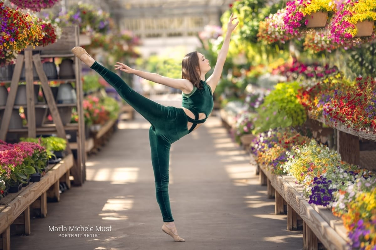 Michigan metro-area dancer's arabesque is beautifully captured in a flower nursery by a skilled portrait photographer from Detroit.