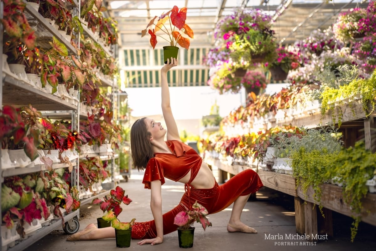 Michigan metro-area dancer's contemporary/lyrical pose is beautifully captured in a flower nursery by a skilled portrait photographer from Detroit.
