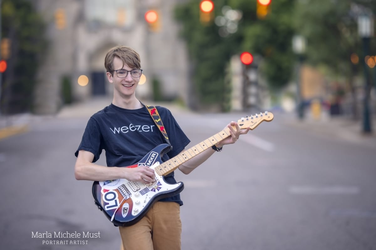 fun senior photo playing guitar in Michigan street
