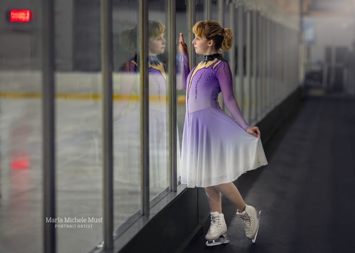 Senior picture at skating rink staring at reflection