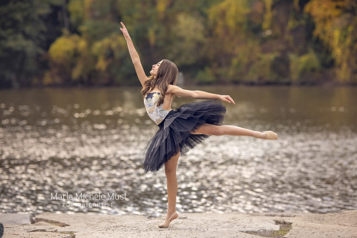 A dancer's arabesque is beautifully captured alongside a Michigan lake by a skilled portrait photographer from Detroit.