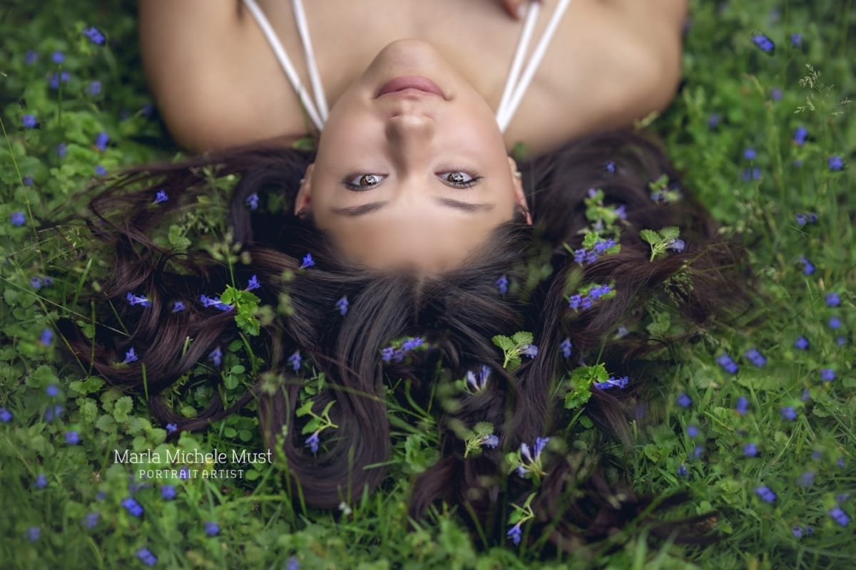 Whimsical senior picture with flowers and moss weaving through hair - A senior portrait captured by Detroit-based high school senior photographer