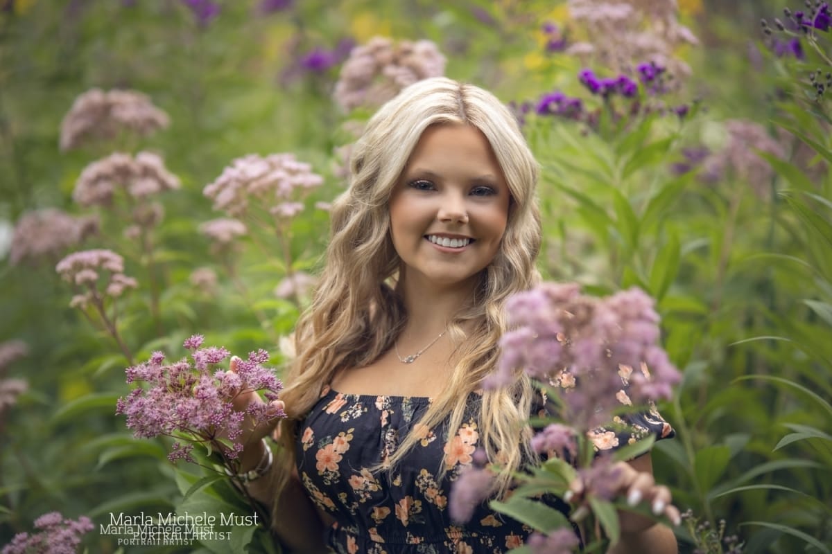 cute senior picture in Michigan park with flowers