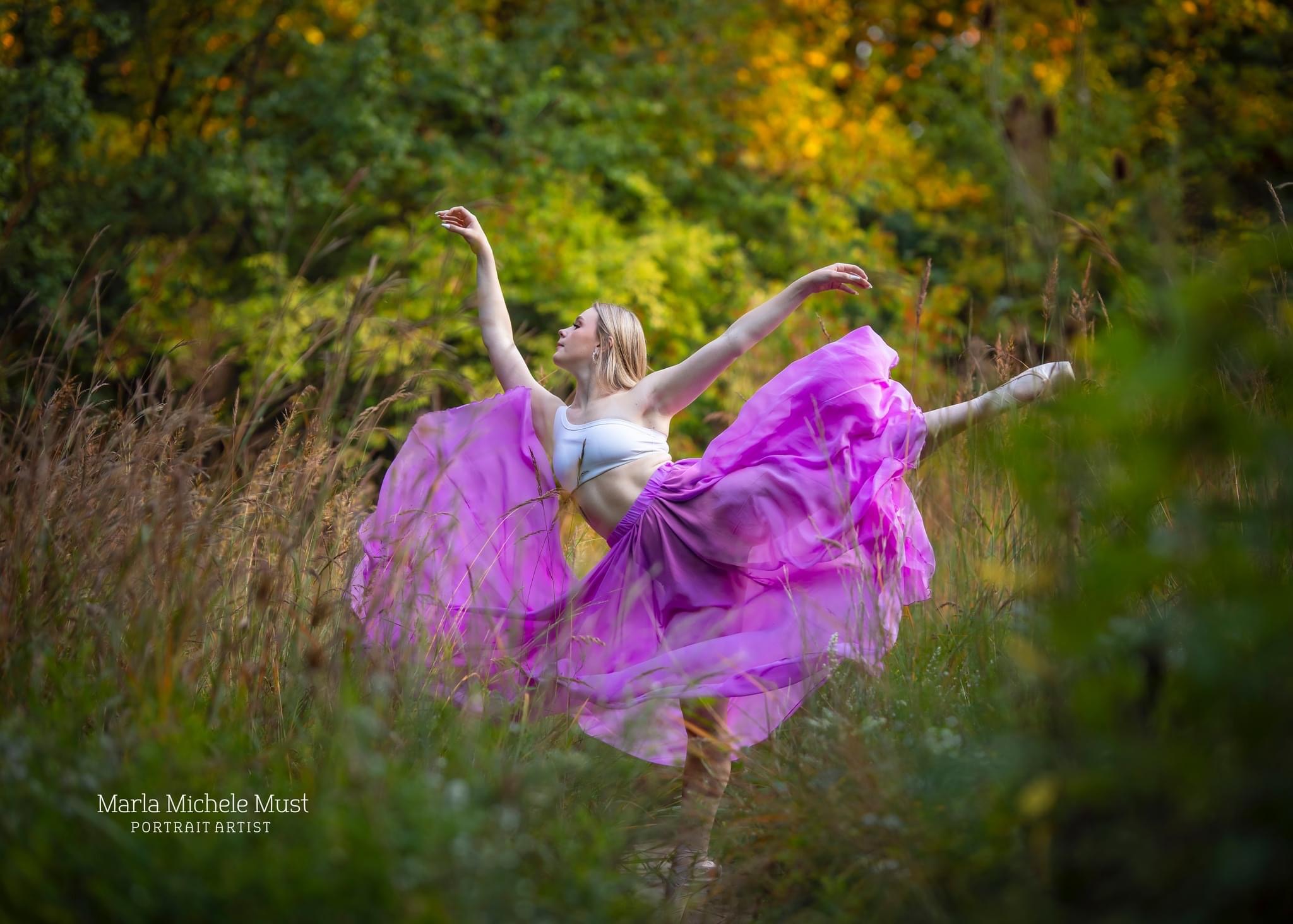 Dancer with flowy dress in a Detroit flowering field during a dance photoshoot
