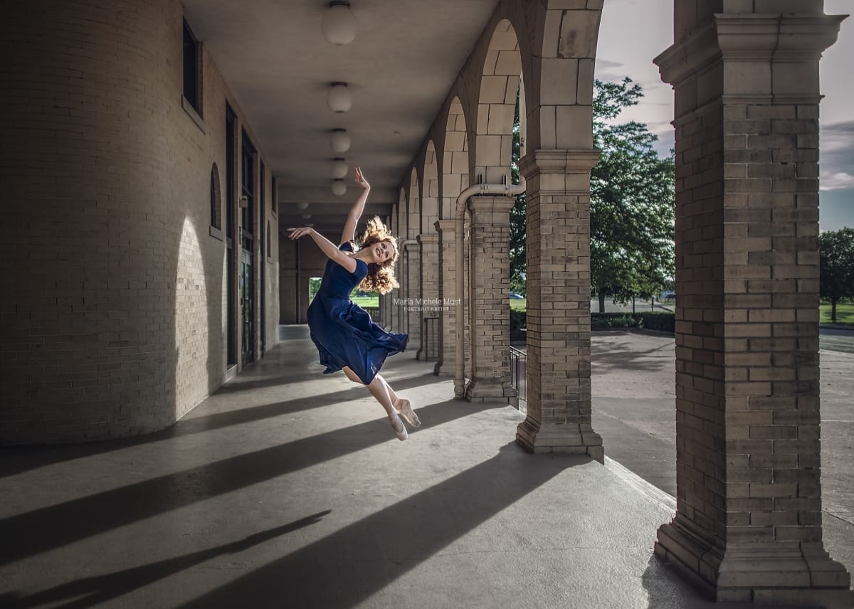 Dancer's leap is skillfully captured by a Detroit photographer during a captivating dancer photoshoot.