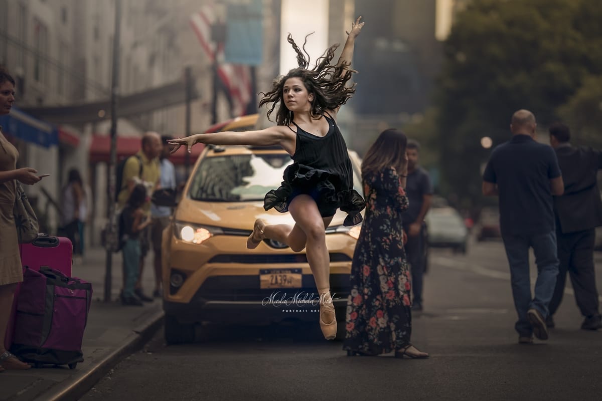 Dancer's leap is skillfully captured by a Detroit photographer during a captivating dancer photoshoot in a Michigan metro area.