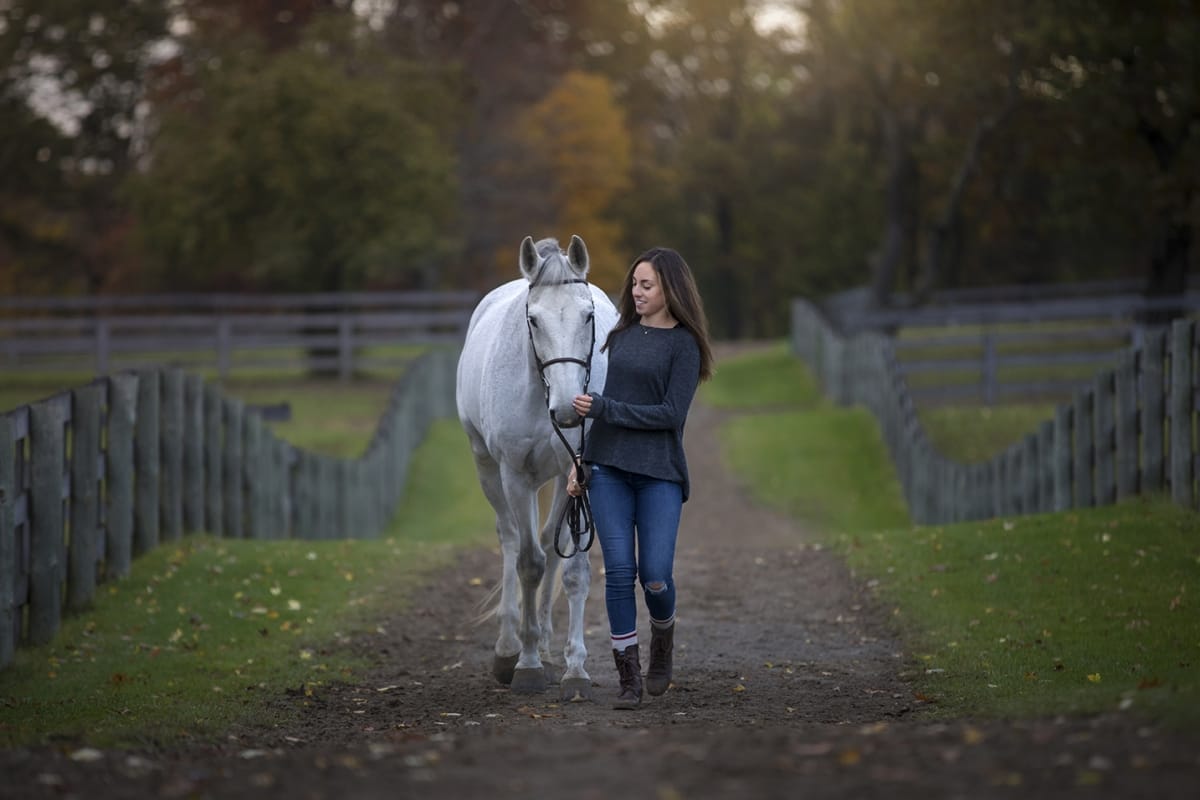 In this expressive portrait taken by a Detroit equine photographer, the horse owner exudes readiness to ride their horse as they walk happily along a trail.