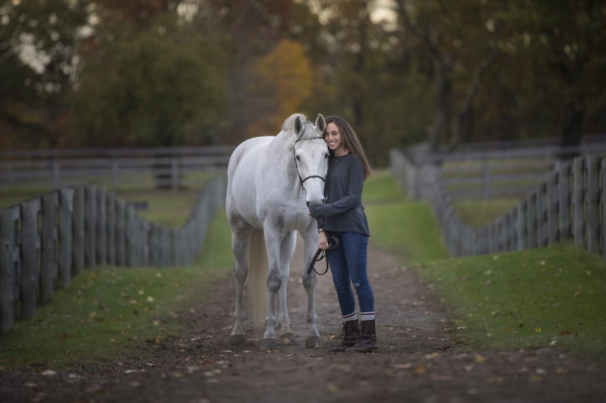In this expressive portrait taken by a Detroit equine photographer, the horse owner exudes readiness to ride their horse as they walk happily along a trail.