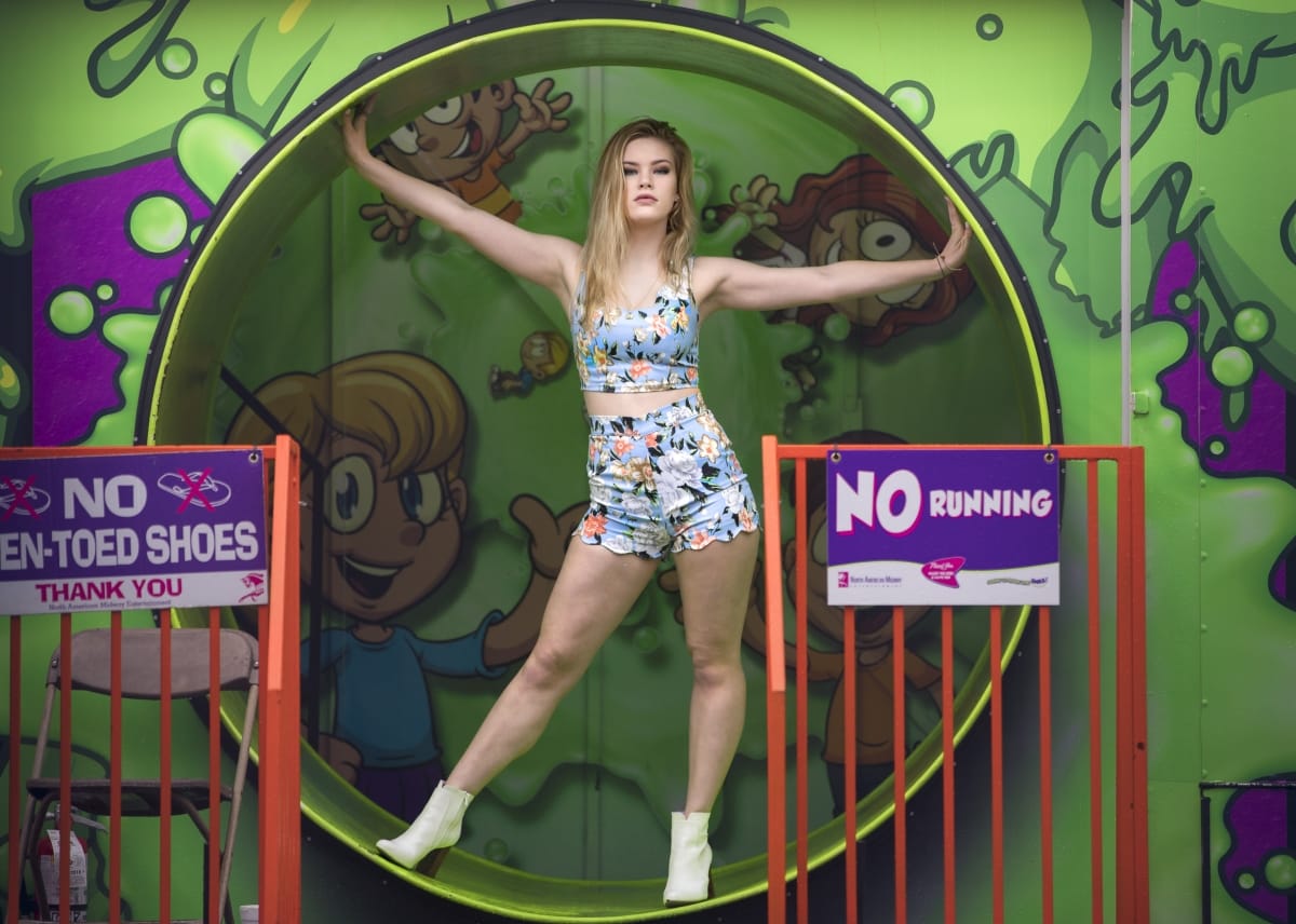 Senior picture taken of a girl posing in a Detroit amusement park attraction