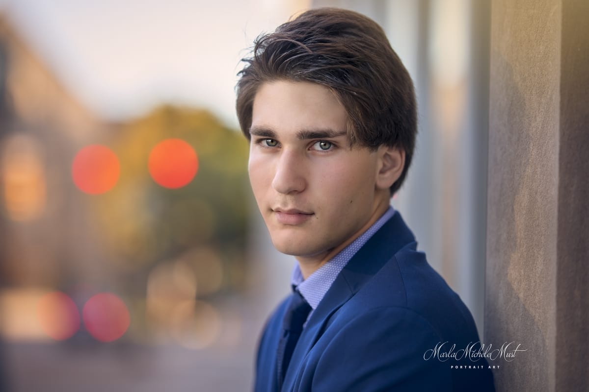 Detroit-area High school senior photo of a young man in formal wear looking directly at the camera in a close-up portrait
