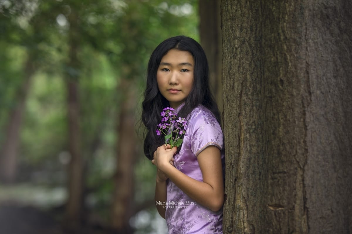Detroit-area High school senior photographer captures the portrait of a young girl holding purple flowers