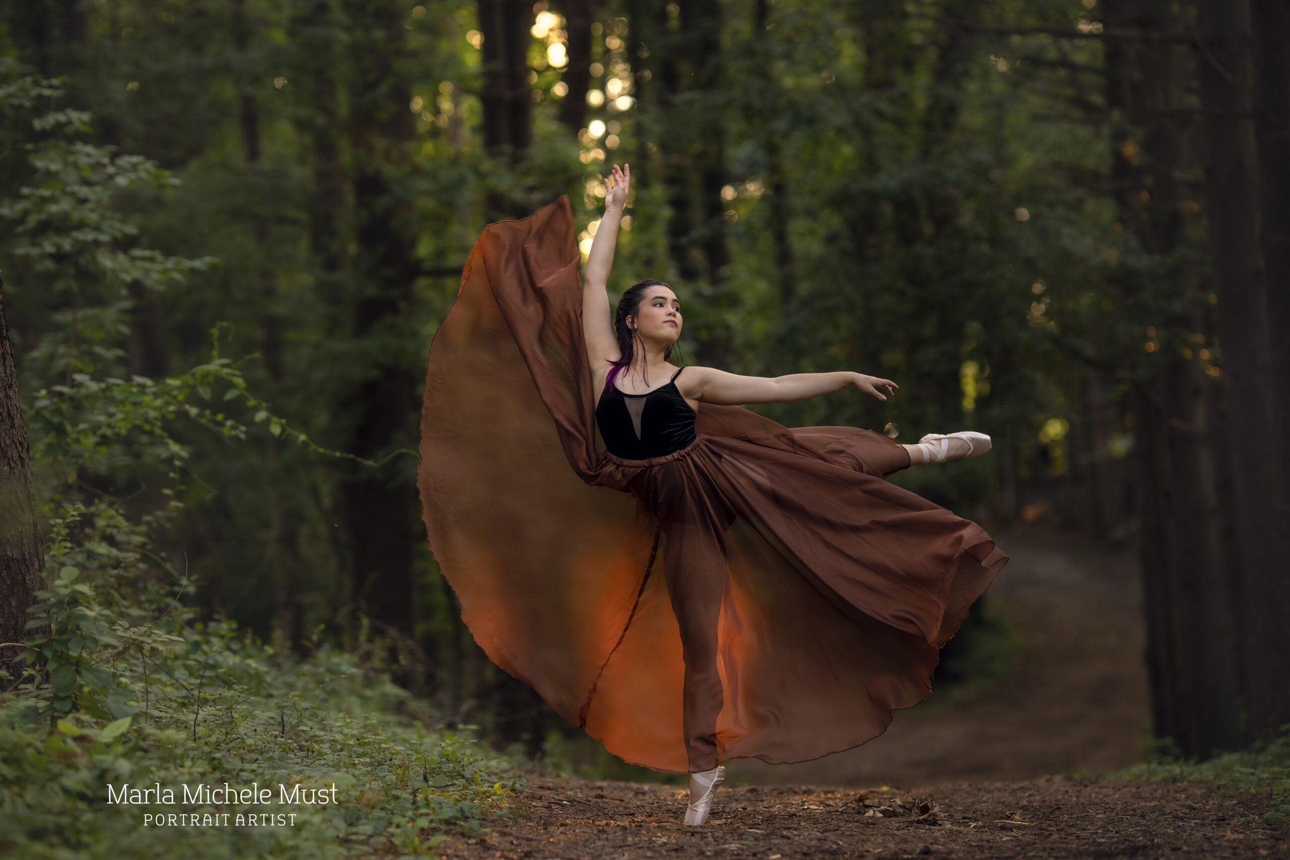 Dancer with flowy dress in a Detroit forest during a dance photoshoot